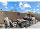 Backyard patio with outdoor seating, gas fireplace, and a decorative wall hanging at 23065 N 75Th St, Scottsdale, AZ 85255