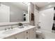 Bright bathroom with a dual sink vanity, large mirror, and a shower-tub combo at 23065 N 75Th St, Scottsdale, AZ 85255