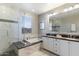 Bright bathroom featuring a glass-enclosed shower, soaking tub, and dual sink vanity at 23065 N 75Th St, Scottsdale, AZ 85255