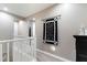 Upstairs hallway featuring railing, carpet, and decorative wall art at 23065 N 75Th St, Scottsdale, AZ 85255