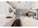 Stylish kitchen featuring a large island with barstool seating, white cabinets, and stainless steel appliances at 23065 N 75Th St, Scottsdale, AZ 85255