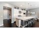 Modern kitchen with a large island with barstool seating, white cabinets, and stainless steel appliances at 23065 N 75Th St, Scottsdale, AZ 85255