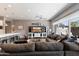 Open concept living room with breakfast bar and dark gray sectional sofa and dark wood floors at 23065 N 75Th St, Scottsdale, AZ 85255