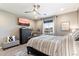 Stylish main bedroom with black furniture and warm, neutral tones and a large window at 23065 N 75Th St, Scottsdale, AZ 85255