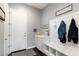 Entryway mud room with a built-in bench, coat hooks, and an exterior door at 23065 N 75Th St, Scottsdale, AZ 85255