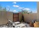 Relaxing patio area with lounge chairs and decorative art under a clear blue sky at 23065 N 75Th St, Scottsdale, AZ 85255