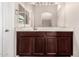 Bathroom vanity featuring a dark wood cabinet, white countertop, and large mirror at 2402 E 5Th St # 1403, Tempe, AZ 85288