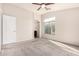 Bedroom featuring neutral carpet, an ensuite bathroom, a window, and a ceiling fan at 2402 E 5Th St # 1403, Tempe, AZ 85288