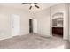 Bedroom with a ceiling fan, neutral carpet, with an ensuite bathroom visible at 2402 E 5Th St # 1403, Tempe, AZ 85288