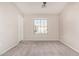 Empty bedroom featuring neutral carpet, a window, and a ceiling fan at 2402 E 5Th St # 1403, Tempe, AZ 85288