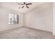 Bedroom with a large window, neutral carpet, and ceiling fan at 2402 E 5Th St # 1403, Tempe, AZ 85288