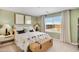 Bedroom with neutral decor, wicker trunk at the end of the bed, and window with blinds at 25083 N 174Th Ln, Surprise, AZ 85387