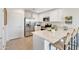 Kitchen with stainless steel appliances, white cabinetry, quartz countertops, and barstool seating at 25083 N 174Th Ln, Surprise, AZ 85387