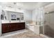 A luxurious bathroom with double sinks, a separate shower, and a soaking tub at 26312 N 132Nd Ln, Peoria, AZ 85383