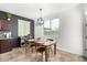 Cozy dining area with modern lighting, table seating, and natural light from large windows at 26312 N 132Nd Ln, Peoria, AZ 85383