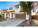 Attractive two-story home features blue shutters, a two-car garage, and low-maintenance landscaping at 26312 N 132Nd Ln, Peoria, AZ 85383