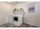 Clean laundry room with side by side washer and dryer, built-in shelves at 26312 N 132Nd Ln, Peoria, AZ 85383