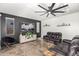 Comfortable living room featuring a dark accent wall and tile flooring at 26312 N 132Nd Ln, Peoria, AZ 85383