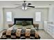 Main bedroom showcasing neutral carpeting and decor, plus bedside tables and ceiling fan at 26312 N 132Nd Ln, Peoria, AZ 85383