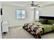 Carpeted main bedroom featuring neutral decor, windows for natural light, and a ceiling fan at 26312 N 132Nd Ln, Peoria, AZ 85383