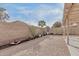 Backyard featuring gravel landscaping, a brick wall, and well-placed greenery at 3147 E Michigan Ave, Phoenix, AZ 85032