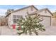 Charming one-story home featuring an attached one car garage, desert landscaping, and mature trees at 3147 E Michigan Ave, Phoenix, AZ 85032