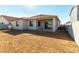 A newly constructed backyard with a covered patio, xeriscaping, and block wall at 31541 N Wet Creek Rd, San Tan Valley, AZ 85143