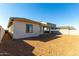 A newly constructed backyard with xeriscaping, a covered patio, and block wall at 31541 N Wet Creek Rd, San Tan Valley, AZ 85143