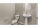 Powder room with a pedestal sink, toilet, and neutral wall color at 31541 N Wet Creek Rd, San Tan Valley, AZ 85143