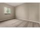 A well-lit bedroom with neutral carpet, a double-pane window, and electrical outlets at 31541 N Wet Creek Rd, San Tan Valley, AZ 85143