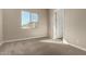 Bedroom featuring carpet, neutral walls, a window, and a white door at 31541 N Wet Creek Rd, San Tan Valley, AZ 85143