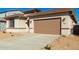 Wide driveway leading to a two-car garage, complemented by desert landscaping at 31541 N Wet Creek Rd, San Tan Valley, AZ 85143