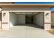 Spacious two-car garage with an automatic door, overhead lighting, and address numbers visible outside at 31541 N Wet Creek Rd, San Tan Valley, AZ 85143