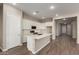 Spacious kitchen features white cabinets, an island with white countertop, and stainless steel appliances at 31541 N Wet Creek Rd, San Tan Valley, AZ 85143