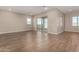 Bright, open-concept living room with tile floors and sliding glass doors to the backyard at 31541 N Wet Creek Rd, San Tan Valley, AZ 85143