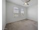 Bright, carpeted bedroom features a ceiling fan and two arched windows offering natural light at 3539 E Starflower Dr, Queen Creek, AZ 85142