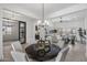 Open-concept dining area with stylish light fixture and modern decor, flowing into the adjacent living spaces at 3539 E Starflower Dr, Queen Creek, AZ 85142