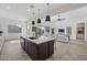 Spacious kitchen with a center island, stainless steel appliances, and seamless flow into living area at 3539 E Starflower Dr, Queen Creek, AZ 85142