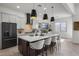 Bright kitchen with a large center island, stylish pendant lights, and ample cabinet space at 3539 E Starflower Dr, Queen Creek, AZ 85142