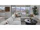 Bright living room featuring a modern sofa, mountain views, stylish pillows and a decorative coffee table at 3539 E Starflower Dr, Queen Creek, AZ 85142