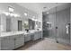 Bright bathroom with double vanity, tiled shower and floors, and modern fixtures at 3539 E Starflower Dr, Queen Creek, AZ 85142