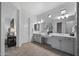 Bright main bathroom with double vanity, quartz counters and tiled floor at 3539 E Starflower Dr, Queen Creek, AZ 85142