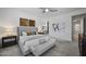 Light filled main bedroom featuring a ceiling fan, a plush bed and stylish decorations at 3539 E Starflower Dr, Queen Creek, AZ 85142