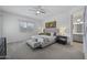 Light filled main bedroom featuring a ceiling fan, a plush bed and stylish decorations at 3539 E Starflower Dr, Queen Creek, AZ 85142