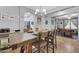 A dining room with a wooden table and seating for four, enhanced by a chandelier at 3553 N 292Nd Dr, Buckeye, AZ 85396