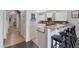 Well-lit kitchen featuring a breakfast bar with stools and modern countertops at 3553 N 292Nd Dr, Buckeye, AZ 85396