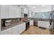 Modern kitchen with white cabinets, granite countertops, and stainless steel appliances at 3553 N 292Nd Dr, Buckeye, AZ 85396