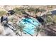 Aerial view of splash pad with shade coverings, benches, and surrounded by palm trees at 3553 N 292Nd Dr, Buckeye, AZ 85396