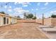 Spacious backyard featuring a brick wall, two lounge chairs, and a large dirt area at 3718 E Sheridan St, Phoenix, AZ 85008