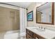 Modern bathroom with a granite vanity and a shower over a tub at 3718 E Sheridan St, Phoenix, AZ 85008